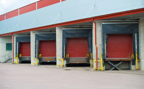 Warehouse with four red sliding gates. — Stock Photo, Image