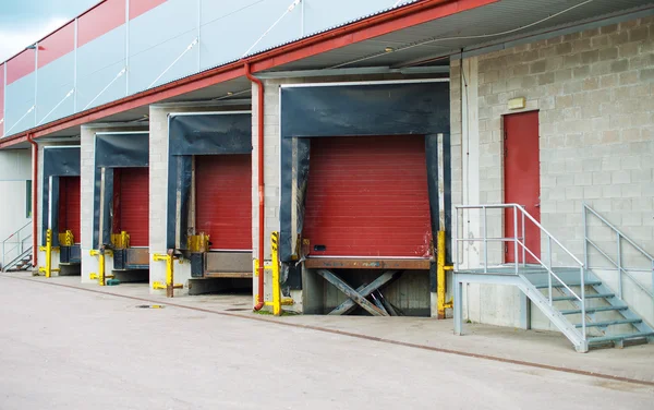 Warehouse with four red sliding gates. — Stock Photo, Image