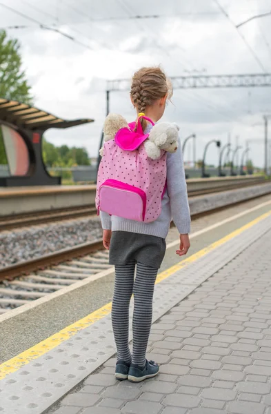 Trenin tren istasyonunda bekleyen küçük kız. — Stok fotoğraf