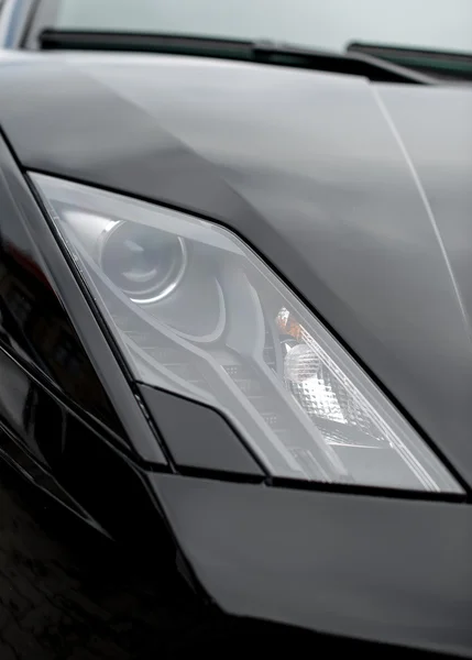 Close-up view of black sports car headlight. — Stock Photo, Image