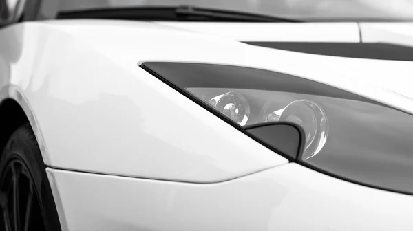 Close-up view of white sports car headlight. — Stock Photo, Image