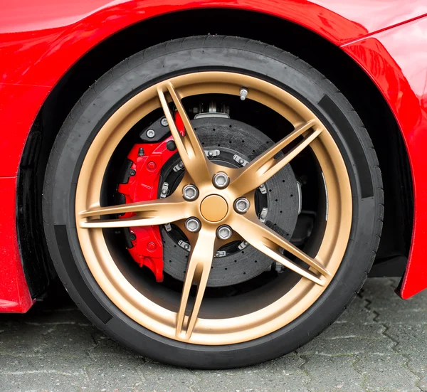 Red sports car wheel on the road. — Stock Photo, Image