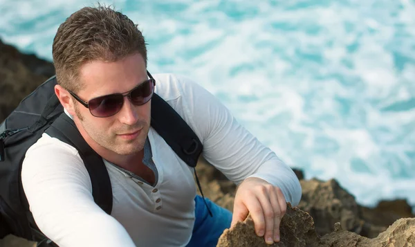 Male tourist with backpack climbing mountains. — Stock Photo, Image