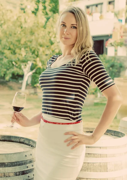 Woman with glass of red wine at the winery. Vintage effect. — Stock Photo, Image
