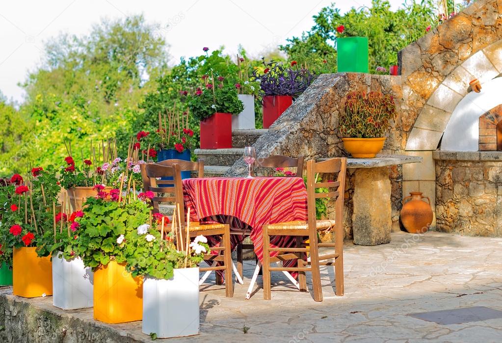 Mediterranean cafe terrace exterior with chairs.