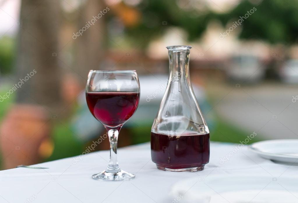 Glass of red wine and bottle in a restaurant.