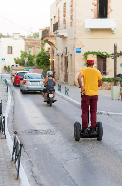 Roadway in the city with cars, scooter and segway. — Stock Photo, Image