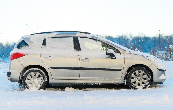 Car covered with snow in the winter.