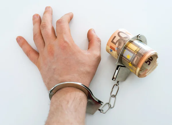 Hand with handcuffs and money. Bribery concept. — Stock Photo, Image