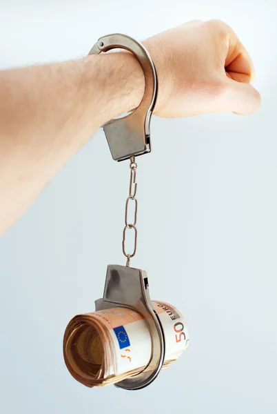 Hand with handcuffs and money. Bribery concept. — Stock Photo, Image