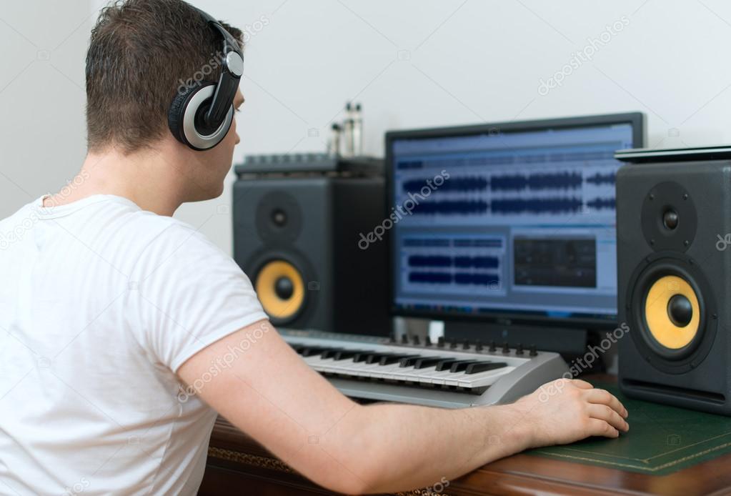 Male sound producer working in recording studio.