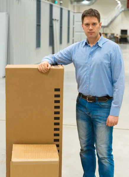 Male worker with boxes at warehouse. — Stock Photo, Image