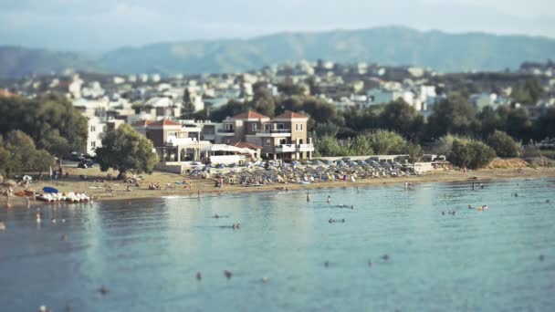 Tropical beach with deckchairs, umbrellas and people. — Stock Video