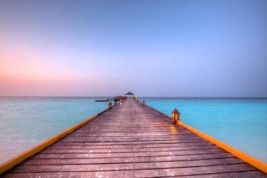 Wooden jetty in sunset clipart