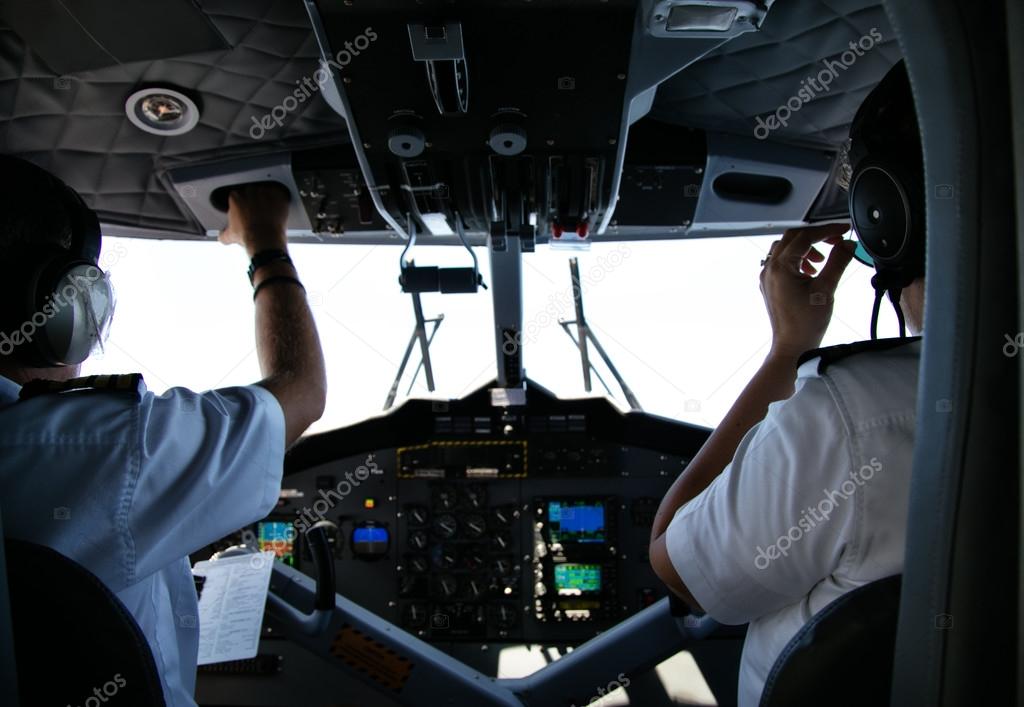 Rear view of pilot and copilot in cockpit