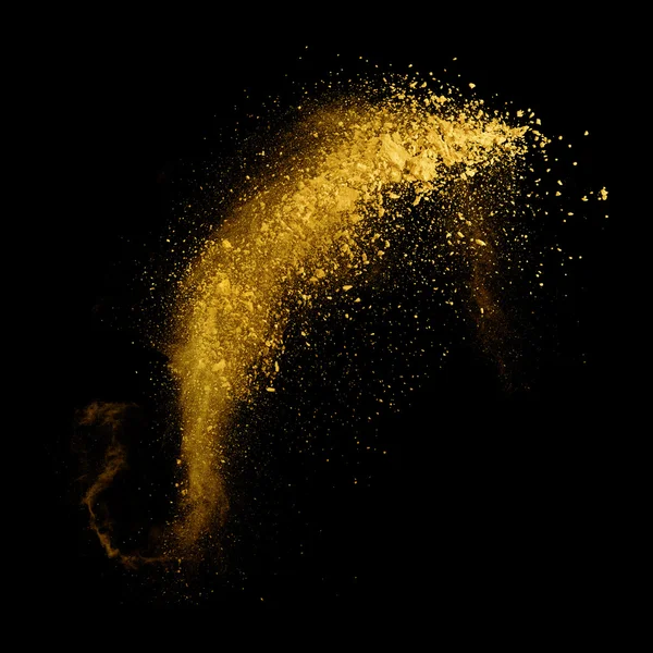 Explosão de pó amarelo sobre fundo preto — Fotografia de Stock