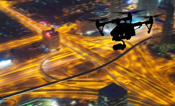 Drone silhouette flying above Dubaicity panorama — Stock Photo, Image