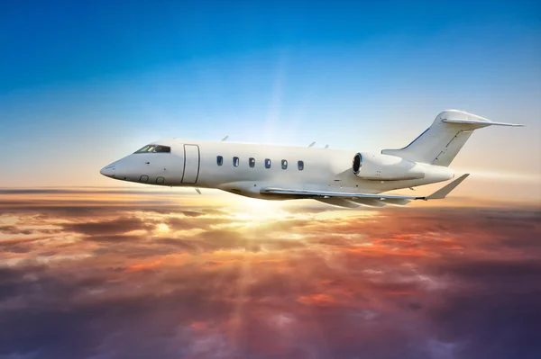 Avión privado volando sobre las nubes al atardecer — Foto de Stock