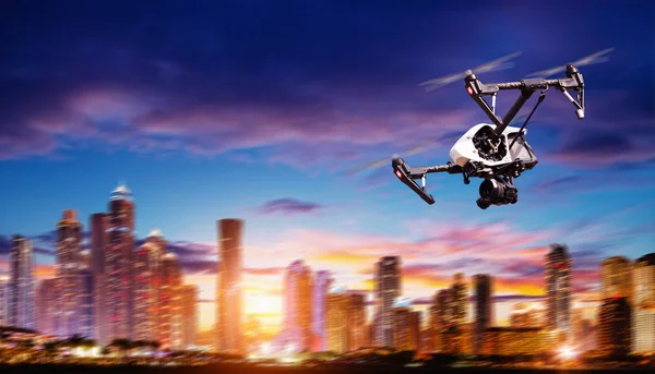 Drone silhouette flying above modern city — Stock Photo, Image