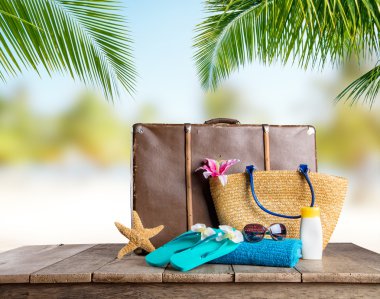 Suitcase and accessories for travelling on wood
