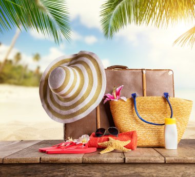 Suitcase and accessories for travelling on wood