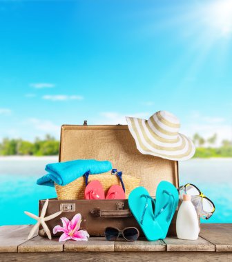 Suitcase and accessories for travelling on wood