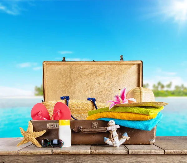 Suitcase and accessories for travelling on wood — Stock Photo, Image