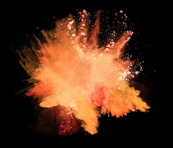 Explosion of orange powder on black background — Stock Photo, Image