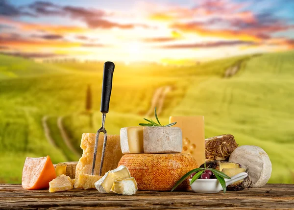 Différents types de fromage placés sur une table en bois — Photo