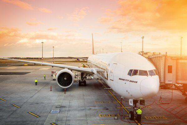 PRAGUE - April 7, 2016: Emirates Boeing 777-300 ER at Vaclav Havel Airport Prague on April 7, 2016, boarding passengers in beautiful sunset