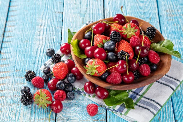Berry fruit in saucer placed on old wooden planks — Stock Photo, Image