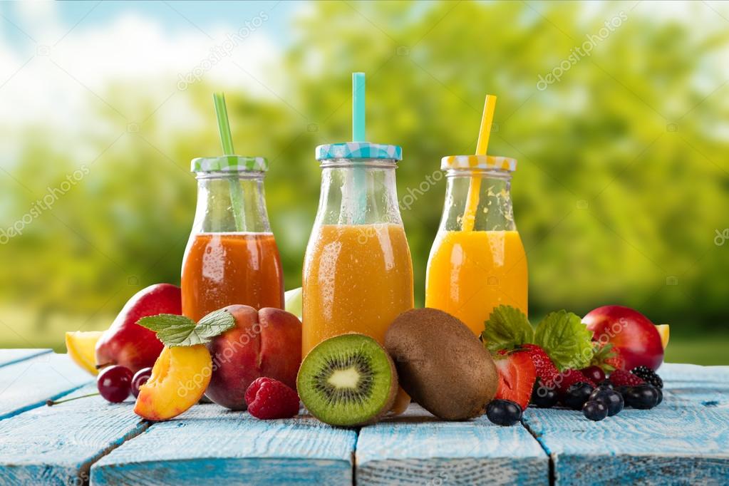Fresh juice with fruit mix on wooden table Stock Photo by ©jag_cz 114867462