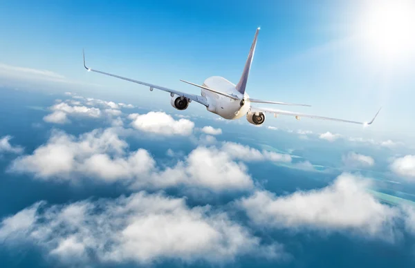 Commercial jet plane flying above clouds — Stock Photo, Image
