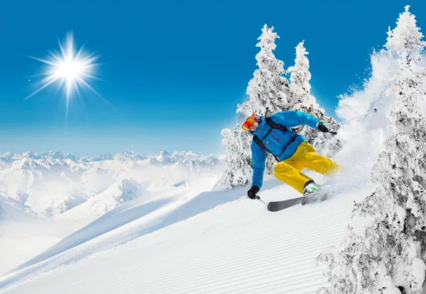 Skier on piste running downhill Stock Image