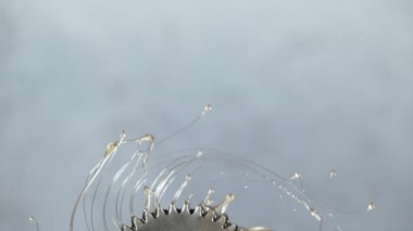 Super slow motion of rotating engine steel wheel with oil splashes. Filmed on high speed cinema camera, 1000 fps.