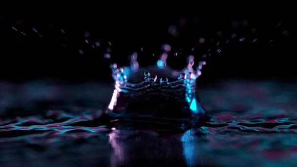 Super Slow Motion Splashing Water Crown Illuminated Neon Lights Filmed — Stock Video