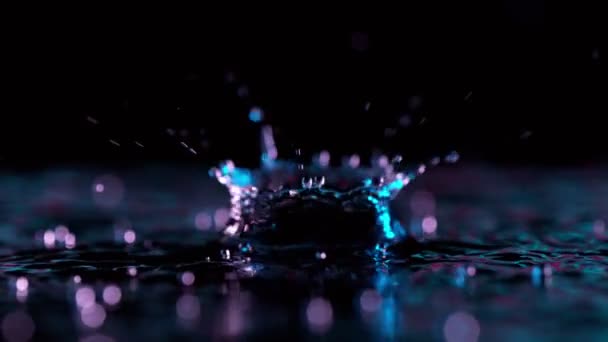 Super Slow Motion Splashing Water Crown Illuminated Neon Lights Filmed — Stock Video