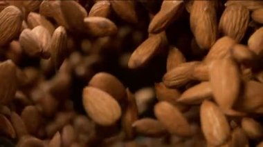 Dönen harekette uçan bademlerin süper yavaş çekimi. Yüksek hızlı sinema kamerası, 1000fps.