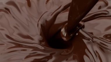 Kasırgaya dökülen koyu sıcak çikolatanın süper yavaş çekimi. Yüksek hızlı sinema kamerasıyla çekildi, 1000fps.