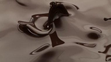 Koyu sıcak çikolatanın çok yavaş sıçratması. Yüksek hızlı sinema kamerası, 1000fps.