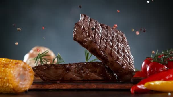 Flying Pieces Grilled Beef Steaks Falling Table Filmed High Speed — Stock Video