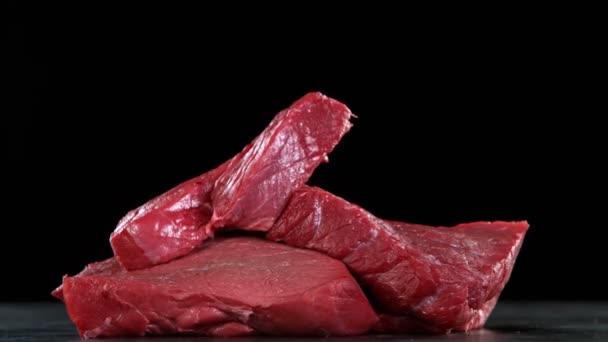 Flying Pieces Raw Beef Steaks Falling Table Filmed High Speed — Stock Video