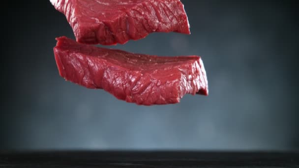 Flying Pieces Raw Beef Steaks Falling Table Spice Filmed High — Stock Video