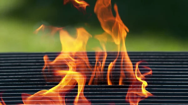 Empty grill grid with fire. Outdoor barbecue preparation, space for product placement.