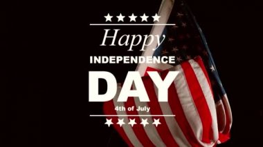 Super slow motion of waving flag of USA with Independence Day text. Filmed on high speed cinema camera, 1000fps.