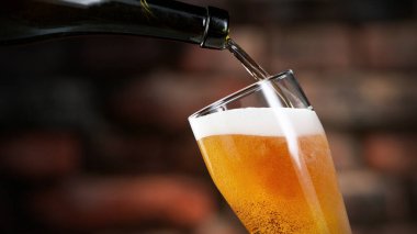 Arka planda zarif tuğla duvarlara bira dökmek. Taze içecekler ve meyhaneler..