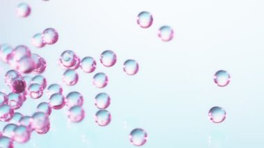 Pembe ve mavi hidrojel toplarının çok yavaş düşüşü. Kozmetik, gençlik ve güzellik konsepti. Yüksek hızlı sinema kamerası, 1000fps