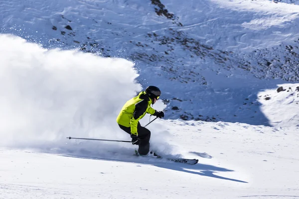 Alpine skier on piste, skiing downhill Stock Picture