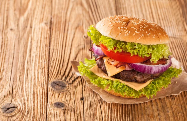 Hamburguesa fresca sobre tablones de madera — Foto de Stock