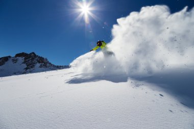 Alpine skier on piste, skiing downhill clipart